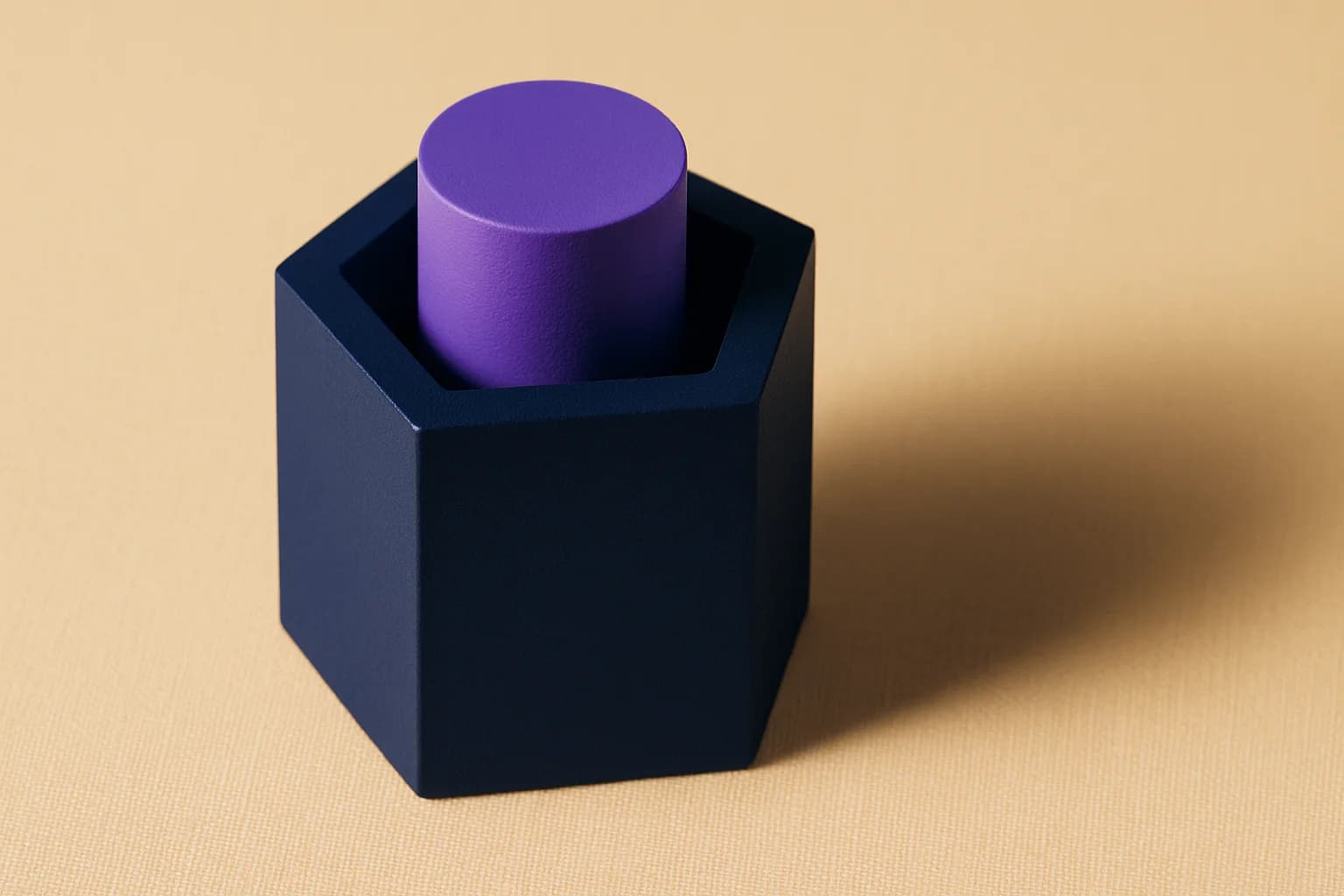 Close-up macro of two nested geometric forms, a larger navy hexagonal prism and a smaller purple cylinder inside it, on a cream surface, representing preferred share seniority containing common stock value